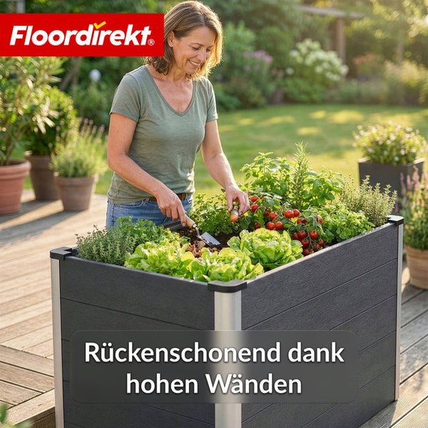 Frau gärtnert in einem Hochbeet mit Gemüse und Kräutern im Garten.