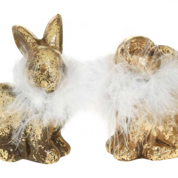 Zwei goldene Hasenfiguren mit weißem Federkranz als Osterdekoration