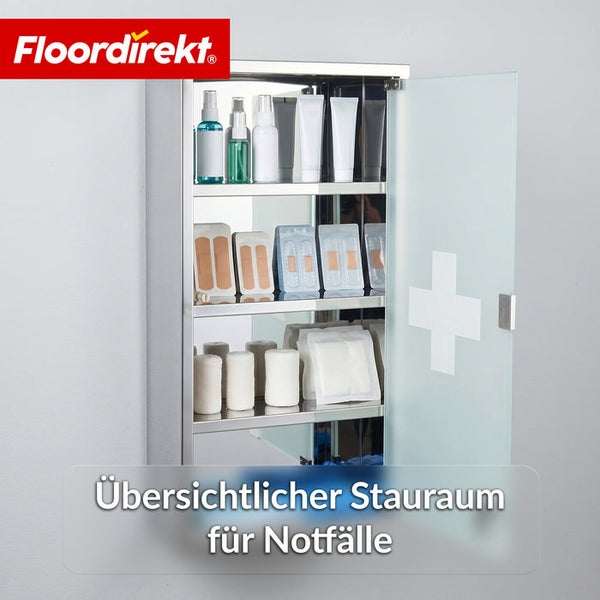 Medizinschrank aus Edelstahl mit offener Milchglastür, Erste-Hilfe-Symbol, gefüllt mit Verbandsmaterial und Medikamenten, Floordirekt Logo.