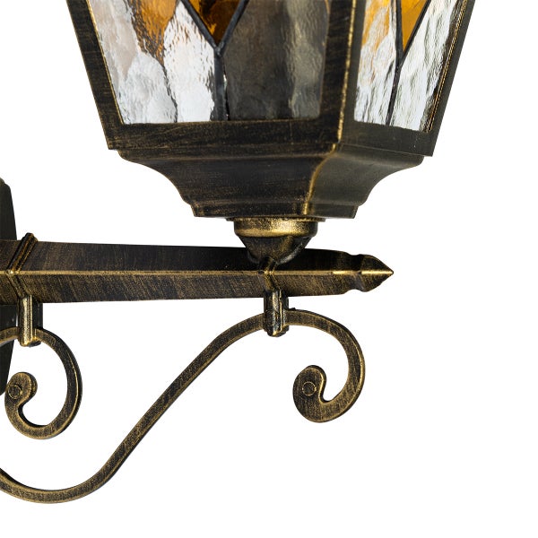 Antike Außenwandleuchte aus Metall in Schwarz-Gold mit strukturiertem Glas und dekorativen Verzierungen.