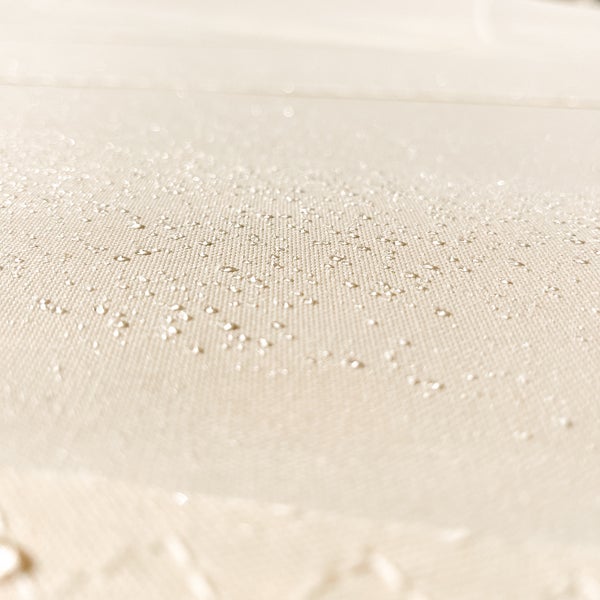 Nahaufnahme von Wassertropfen auf einer wasserabweisenden Stoffoberfläche.