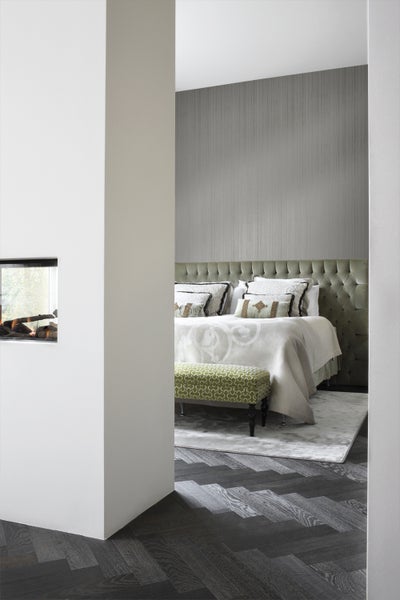 Schlafzimmer mit Bett, Bank und Kamin