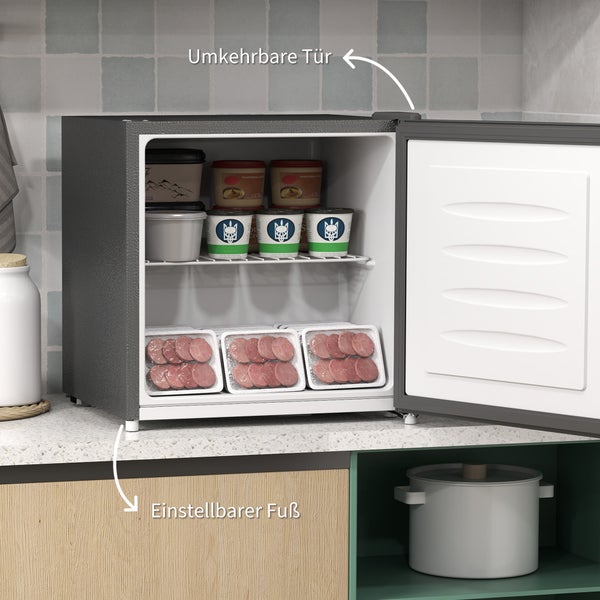 Kleiner Gefrierschrank mit offener Tür, gefüllt mit Lebensmitteln, mit Hinweis auf umkehrbare Tür und einstellbaren Fuß.