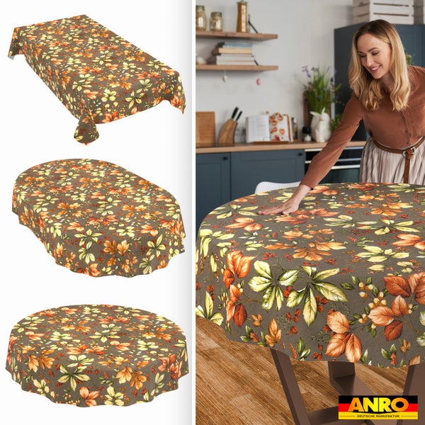 Tischdecke mit herbstlichem Blättermuster in rechteckiger, ovaler und runder Ausführung, eine Frau deckt einen Tisch in einer Küche, ANRO Logo.