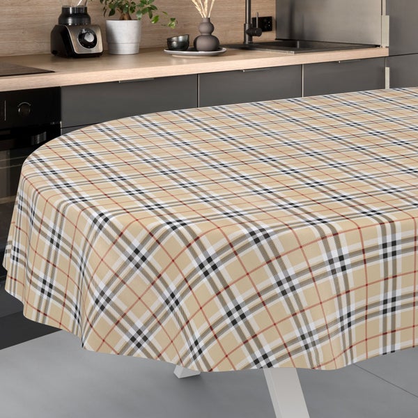 Tischdecke mit Karomuster auf einem ovalen Tisch in einer hellen, modern eingerichteten Küche.