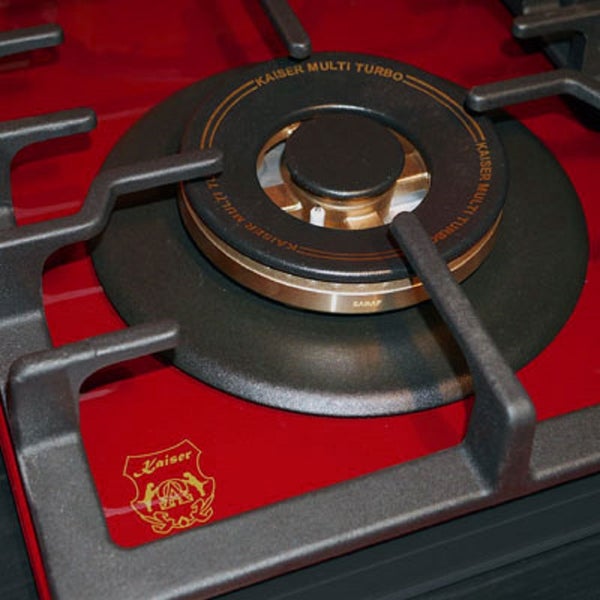 Detailansicht eines Kaiser Multi Turbo Gasbrenners auf einem Gaskochfeld mit gusseisernem Topfträger und Kaiser Logo