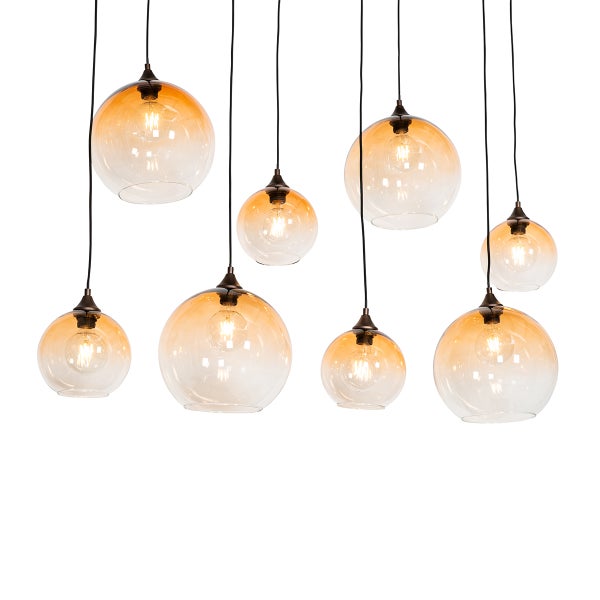 Mehrflammige Pendelleuchte mit transparenten, kugelförmigen Glasschirmen