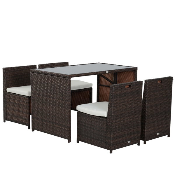 Platzsparendes Gartenmöbel-Set aus Polyrattan, bestehend aus einem rechteckigen Tisch mit Glasplatte und vier Stühlen mit hellen Sitzkissen.