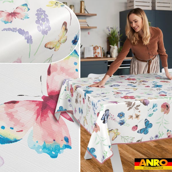 Abwischbare Tischdecke mit bunten Schmetterlingen und Blumen auf einem Küchentisch, ANRO Logo.