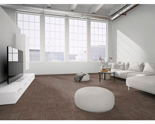 Strukturierter Teppichboden in einem hellen, modernen Wohnzimmer mit großen Fenstern, weißem Sofa und industriellen Deckendetails.
