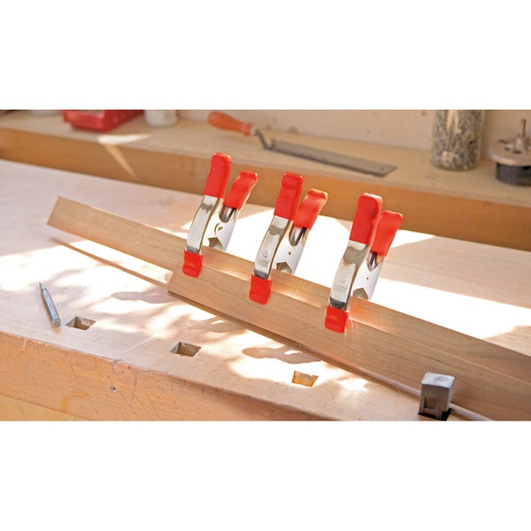 Holzwerkbank mit Federzwingen, Holzlatte und Werkzeugen