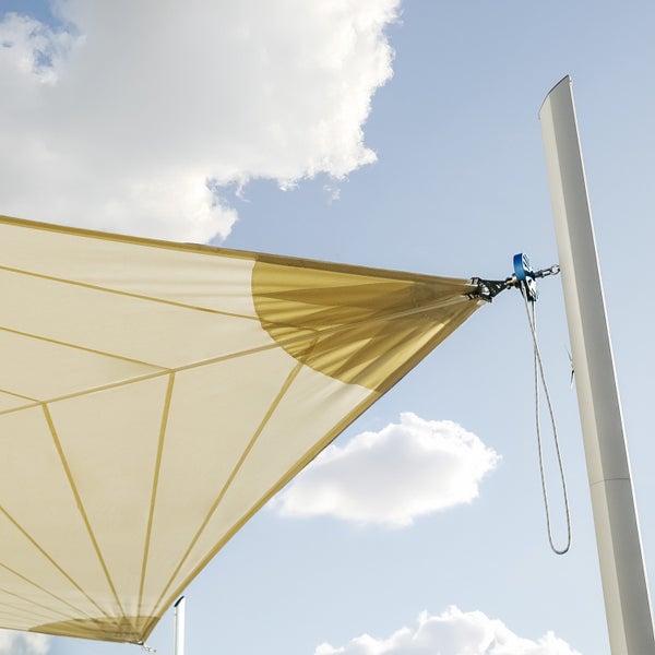 Sonnensegel mit Befestigung an einem Mast über ein Rollensystem mit Seilzug.