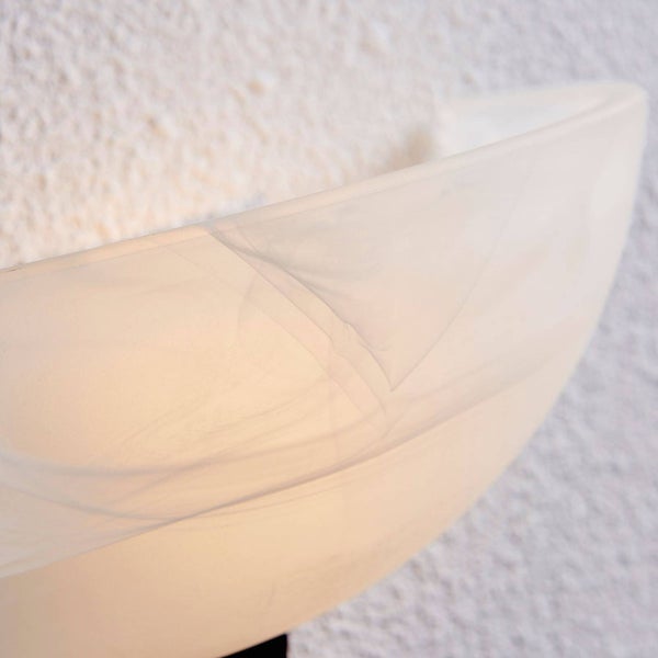 Nahaufnahme einer Wandleuchte mit einem halbkreisförmigen Glasschirm in Marmor-Optik vor einer strukturierten Wand.