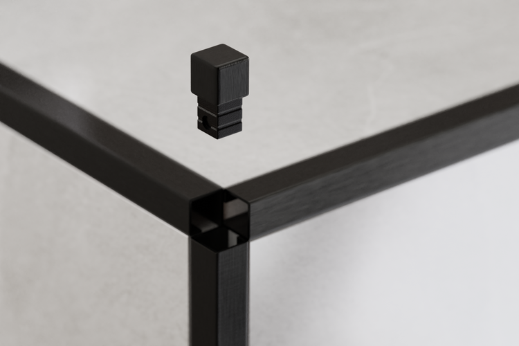Detailaufnahme einer schwarzen Möbelkonstruktion mit einem dazugehörigen Verbindungsstück.