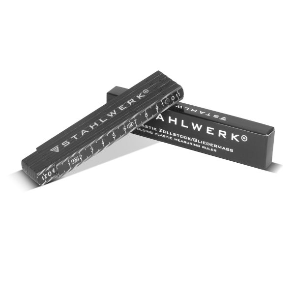 STAHLWERK Gliedermass aus schwarzem Kunststoff, zusammengeklappt, mit Originalverpackung.