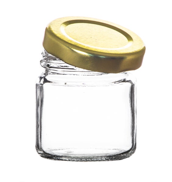 Leeres Glas mit goldenem Deckel