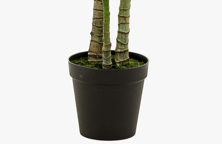 Künstliche Palme mit grünen Blättern zur Dekoration.