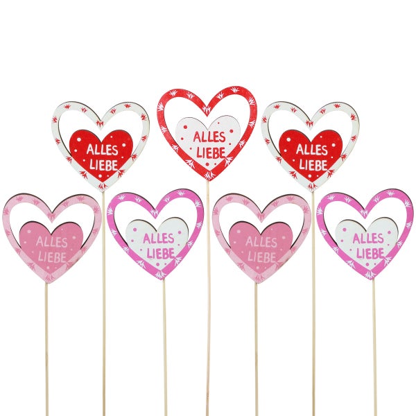Dekorative Herzstecker mit der Aufschrift Alles Liebe als Tischdekoration