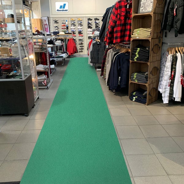 Blick in ein Bekleidungsgeschäft mit Auslegware auf dem Boden