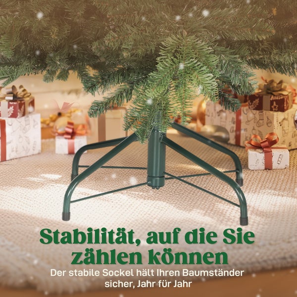 Stabiler Christbaumständer aus grünem Metall unter einem künstlichen Weihnachtsbaum, umgeben von Geschenken auf einem Teppich in hellem Ambiente.