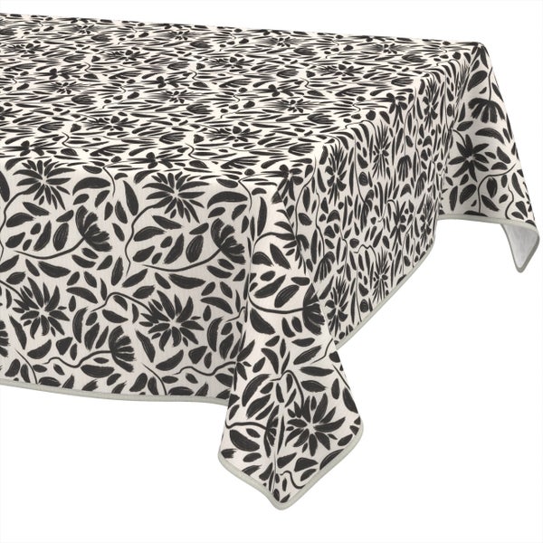 Tischdecke mit floralem Muster und Blättermotiv.