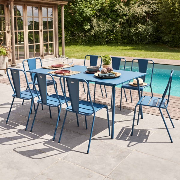 Modernes Gartenmöbel-Set aus blauem Metall bestehend aus einem rechteckigen Esstisch und acht Stühlen auf einer Terrasse am Pool.