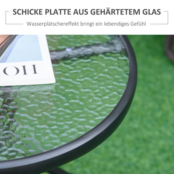 Nahaufnahme eines runden Gartentisches mit einer Tischplatte aus gehärtetem Glas mit Wasserwellenstruktur und schwarzem Rahmen.