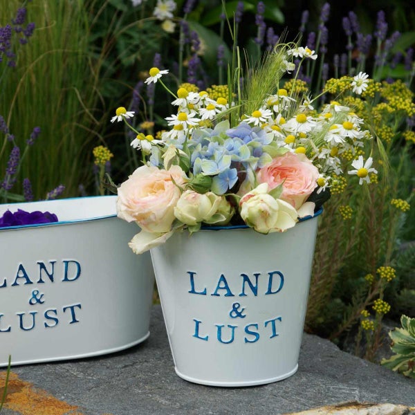 Dekorative Übertöpfe mit Blumenarrangement für den Außenbereich