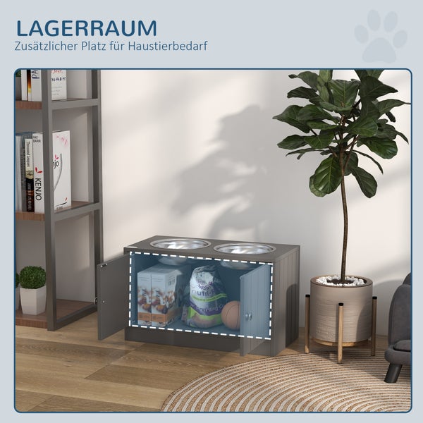 Hundefutterstation mit integriertem Stauraum für Tierbedarf in einem hellen Wohnzimmer neben einem Bücherregal und einer Zimmerpflanze.
