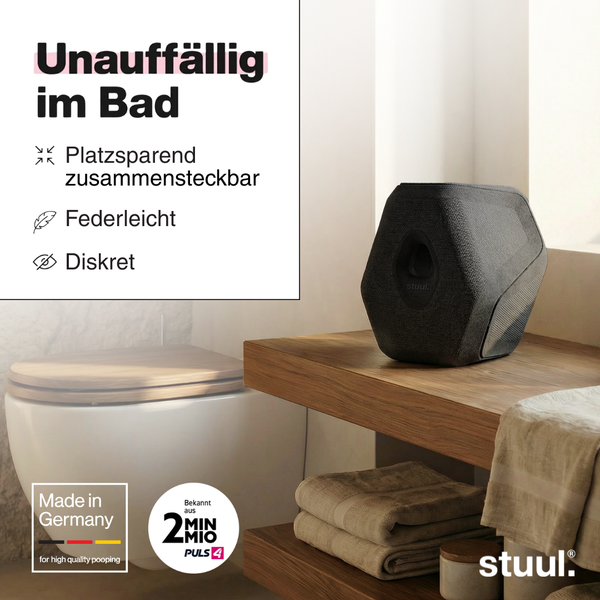 Schwarzer stuul Toilettenhocker in modernem Badezimmer auf Holzregal, platzsparend, strukturiertes Material, Siegel für deutsche Herstellung, stuul Logo.