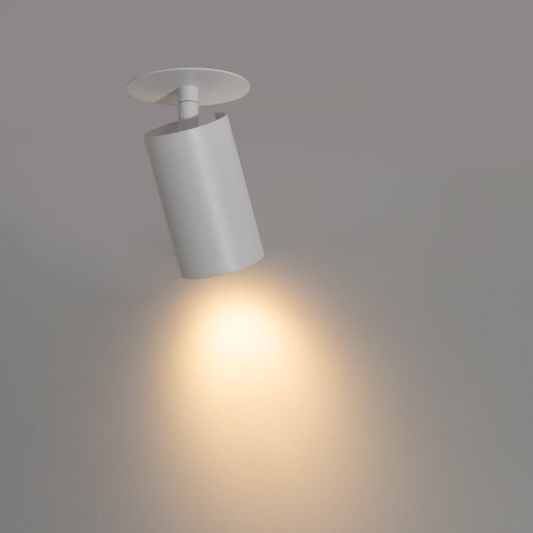 Zylindrischer Deckenstrahler aus Metall in Weiß, schwenkbar, mit warmem Lichtkegel.