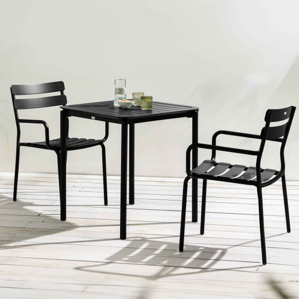 Dreiteiliges Gartenmöbel-Set aus schwarzem Aluminium mit einem quadratischen Lamellentisch und zwei Stühlen mit Armlehnen auf einer Holzterrasse.