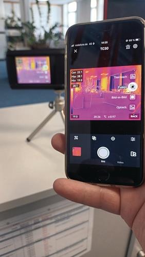 Eine Wärmebildkamera zeigt ein Wärmebild auf einem Smartphone