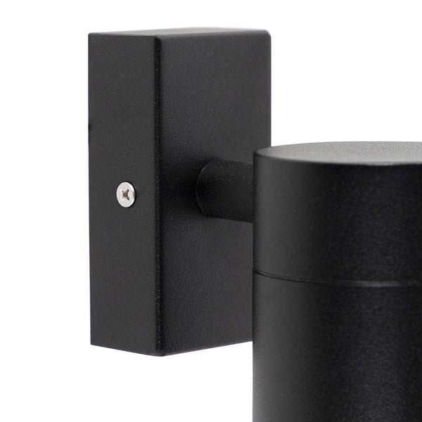 Nahaufnahme einer schwarzen Wandhalterung für eine Außenleuchte mit rechteckiger Halterung und zylindrischem Lampenkopf.