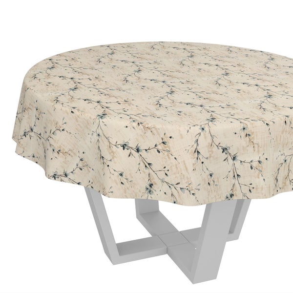 Rundes Tischtuch mit floralem Zweigmuster auf einem Tisch mit modernem Gestell.