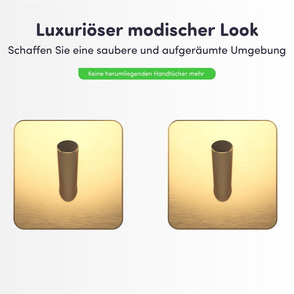 Zwei quadratische Handtuchhaken aus gebürstetem Metall in Goldoptik mit einem zylindrischen Stift.