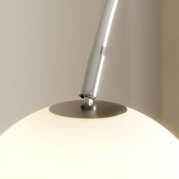 Nahaufnahme einer Lampe mit Chromarm und einem Lampenschirm