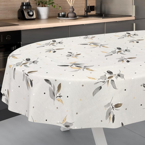 Ovale Tischdecke mit einem Muster aus Blättern und Punkten auf einem Tisch in einer modernen Küche.