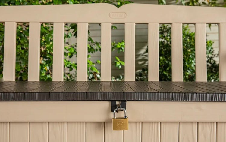 Abschließbare Gartenbank aus Kunststoff mit integrierter Auflagenbox in Holzoptik und einem Vorhängeschloss.