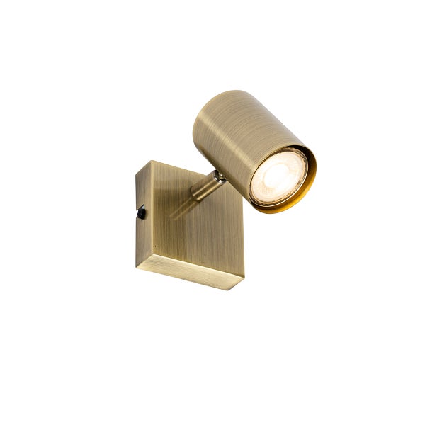 Wandspot aus Metall in Messing antik mit zylindrischem Kopf und Schalter am Sockel.