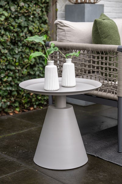 Moderner runder Garten-Beistelltisch aus Metall mit kegelförmigem Standfuß und zwei weißen Vasen auf einer Terrasse.