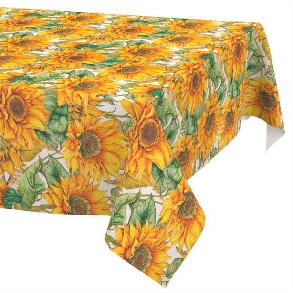 Tischdecke mit Sonnenblumen-Motiv und grünen Blättern.