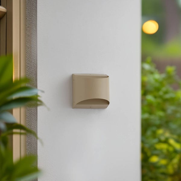 Moderne beige Außenwandleuchte aus Metall mit Lichtaustritt oben und unten, montiert an einer hellen Wand im Außenbereich.