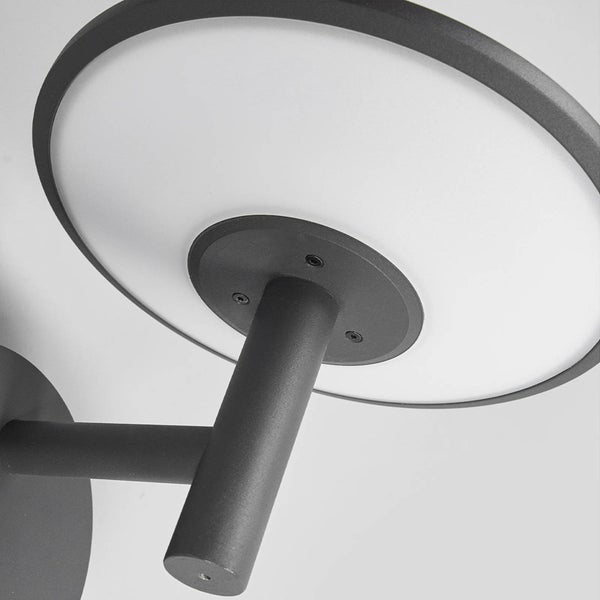 Moderne Wandleuchte aus Metall mit rundem Leuchtschirm und weißem Diffusor.