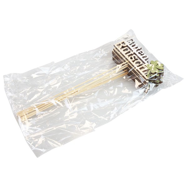 Verpackung mit Holzsteckern mit der Aufschrift Guten Rutsch und Kleeblättern