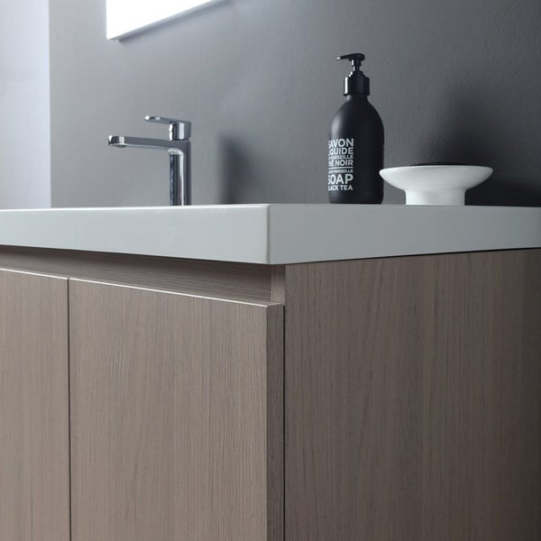 Badezimmerwaschtisch mit Waschbecken, Armatur, Seifenspender und Seifenschale.