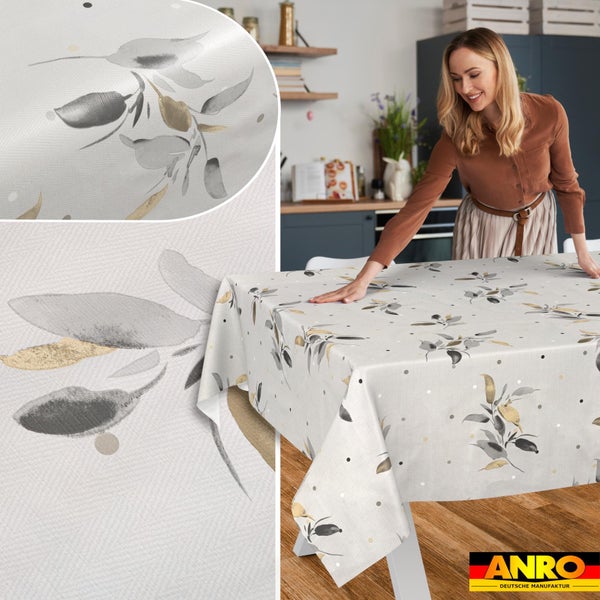 Abwaschbare Wachstuch-Tischdecke mit Blattmuster und Punkten auf einem Tisch in einer hellen Küche sowie Detailansicht der Materialoberfläche.