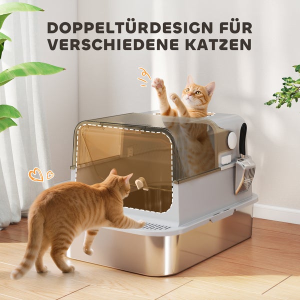 Geschlossene Katzentoilette mit Doppeltür-Design, Edelstahlschale und zwei spielenden roten Katzen in einem hellen Raum.