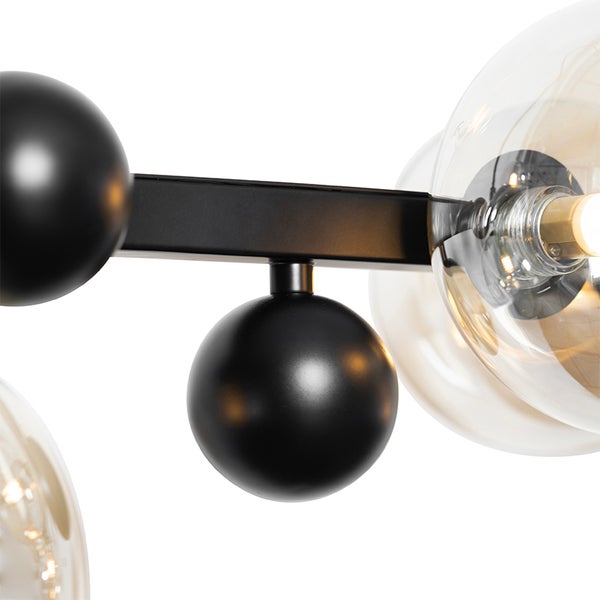 Detailaufnahme einer Lampe mit Glaskugeln und schwarzen Akzenten