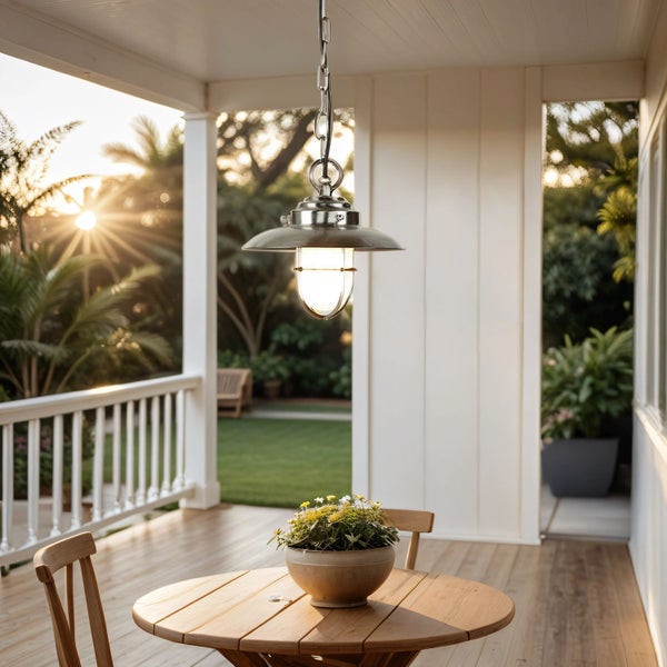 Eine Terrasse mit einem Holztisch, Stühlen und einer Hängelampe.